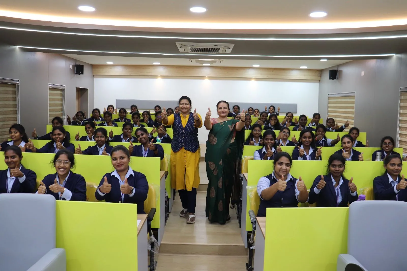 MBA students in navy blazers in a TIBM lecture hall
